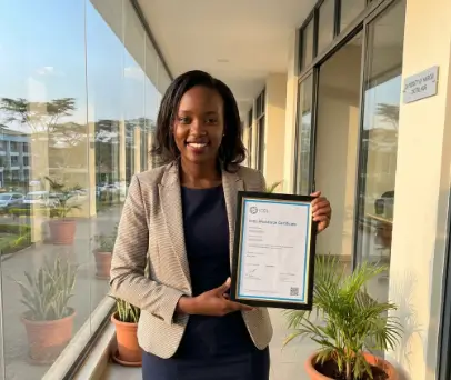 Graduate holding an ICDL certificate after completing training at Excel Global College